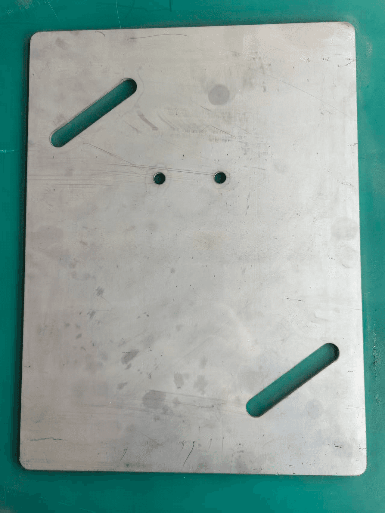 Base plate with slots and drilled holes