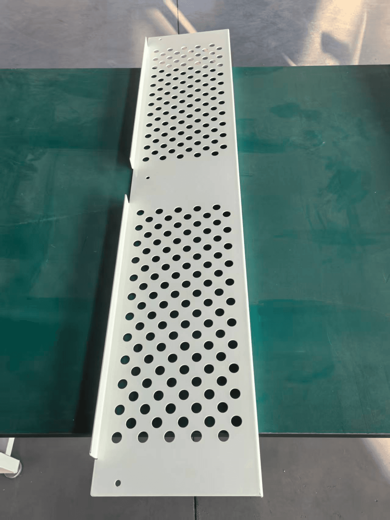 Elongated perforated panel with bent edge